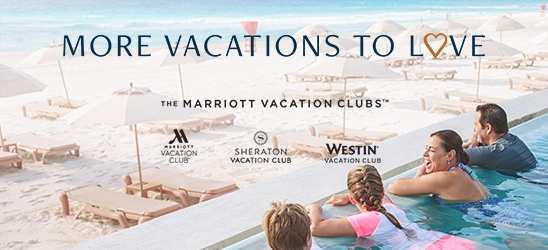 Family overlooks the beach and beach umbrellas from an infinity pool on vacation