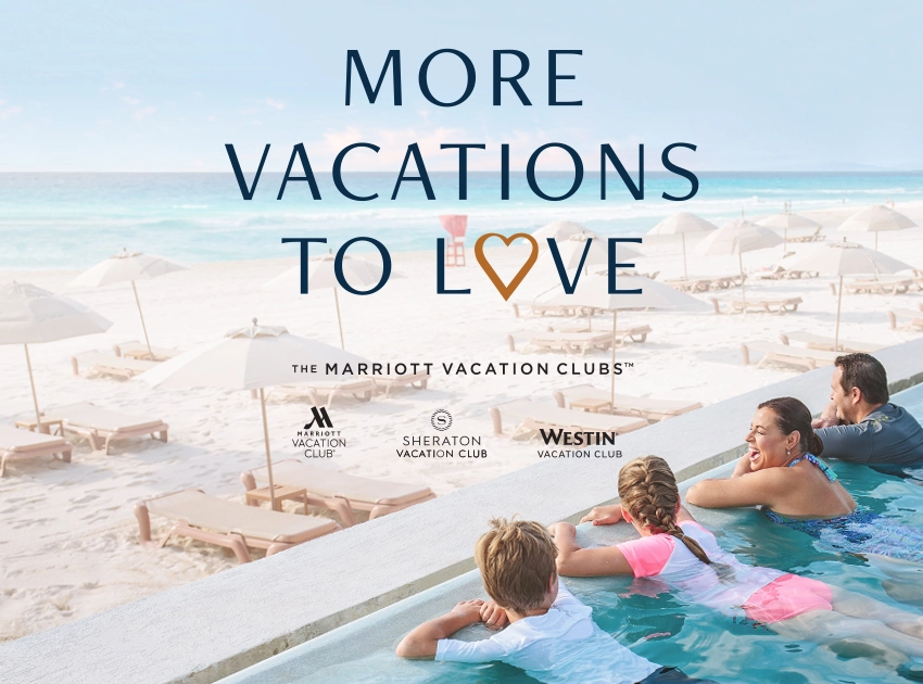Family overlooks the beach and beach umbrellas from an infinity pool on vacation